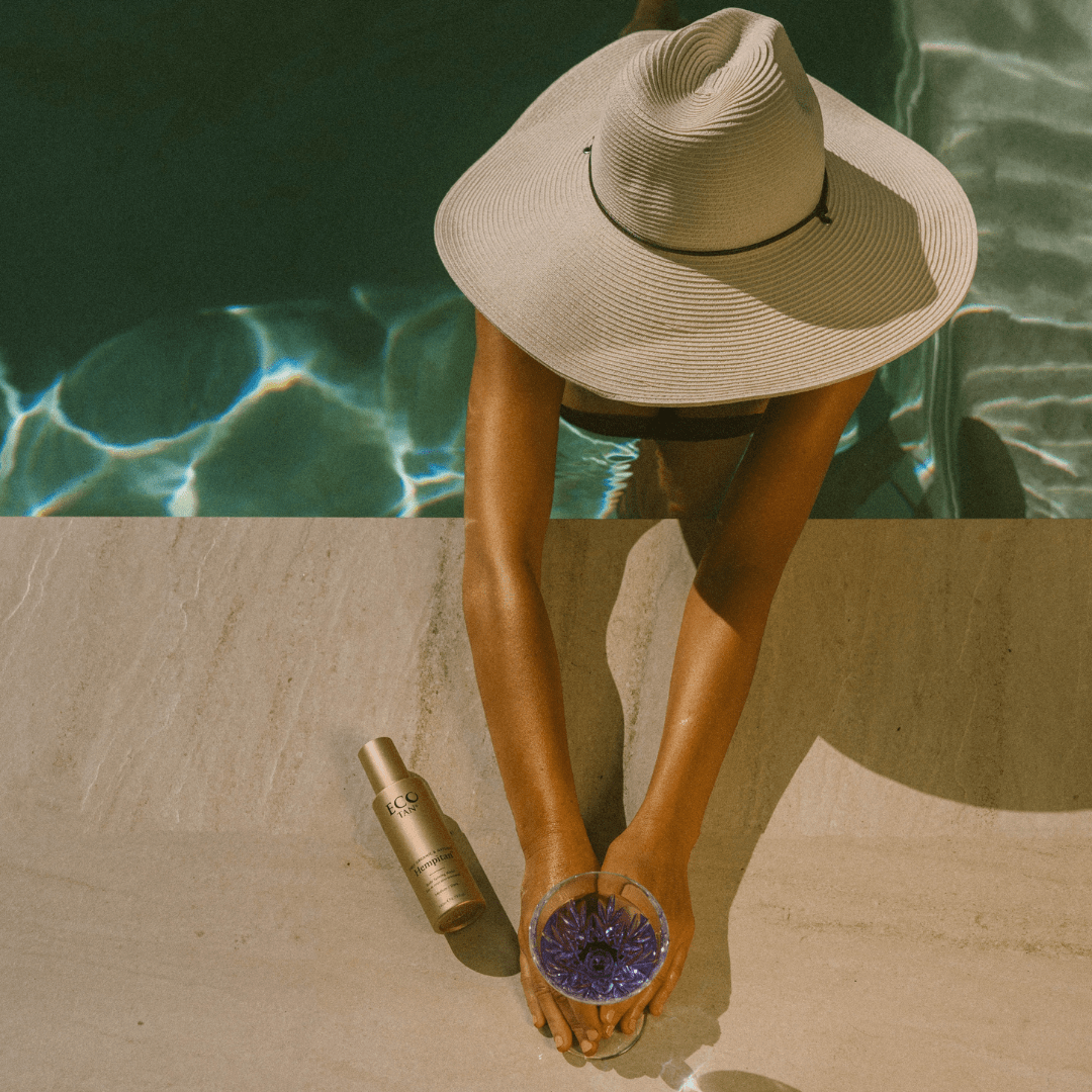 Eco Tan Hempitan natural sunless tanning water in pool with tanned arms